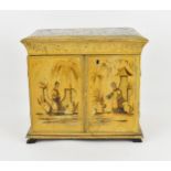 A Regency period Chinoiserie yellow lacquered and painted vanity cabinet, with hinged lid