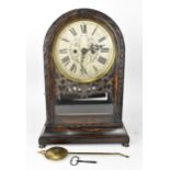 An early Victorian coromandel mantle clock, the silvered dial having a floral engraved centre with