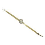 A Tissot manual wind, ladies 9ct gold wristwatch, the dial having baton markers and signed Tissot,