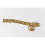 A 15ct yellow gold gatelink bracelet, with heart padlock clasp and safety chain, stamped 15ct,