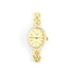 A Longines quartz, ladies 14ct gold wristwatch having a diamond bezel, gilt dial with baton markers,