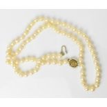 A single strand of cultured white pearls, with 9ct yellow gold, seed pearl and oval cut citrine