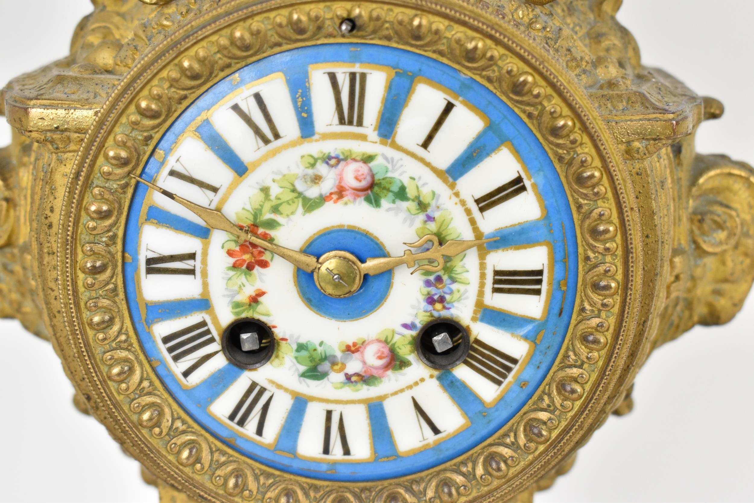 A 19th century French gilt metal mantle clock having a flower shaped finial on a twin handled urn - Image 2 of 11