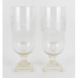 A pair of cut and engraved glass hurricane candlesticks, the shades with wheel engraved foliate