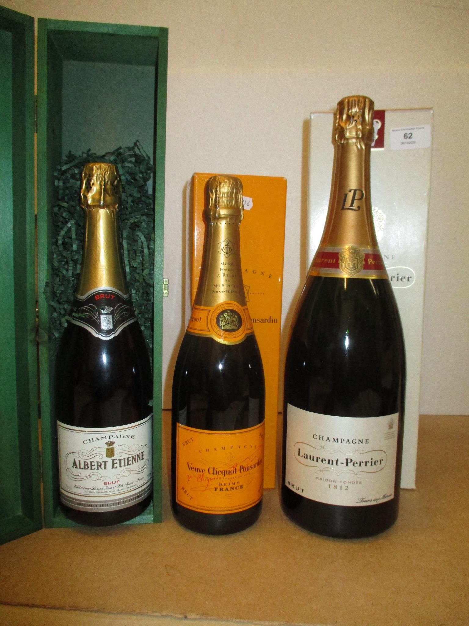 One bottle of Albert Etienne Champagne, one bottle of Veuve Clicquot Champagne, and Laurent