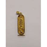 A Egyptian gold pendant decorated with hieroglyphics, tested as 14ct, 8.3g Location: