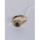 An 18ct gold ring with a ruby and illusion set diamonds, 3.2g Location: