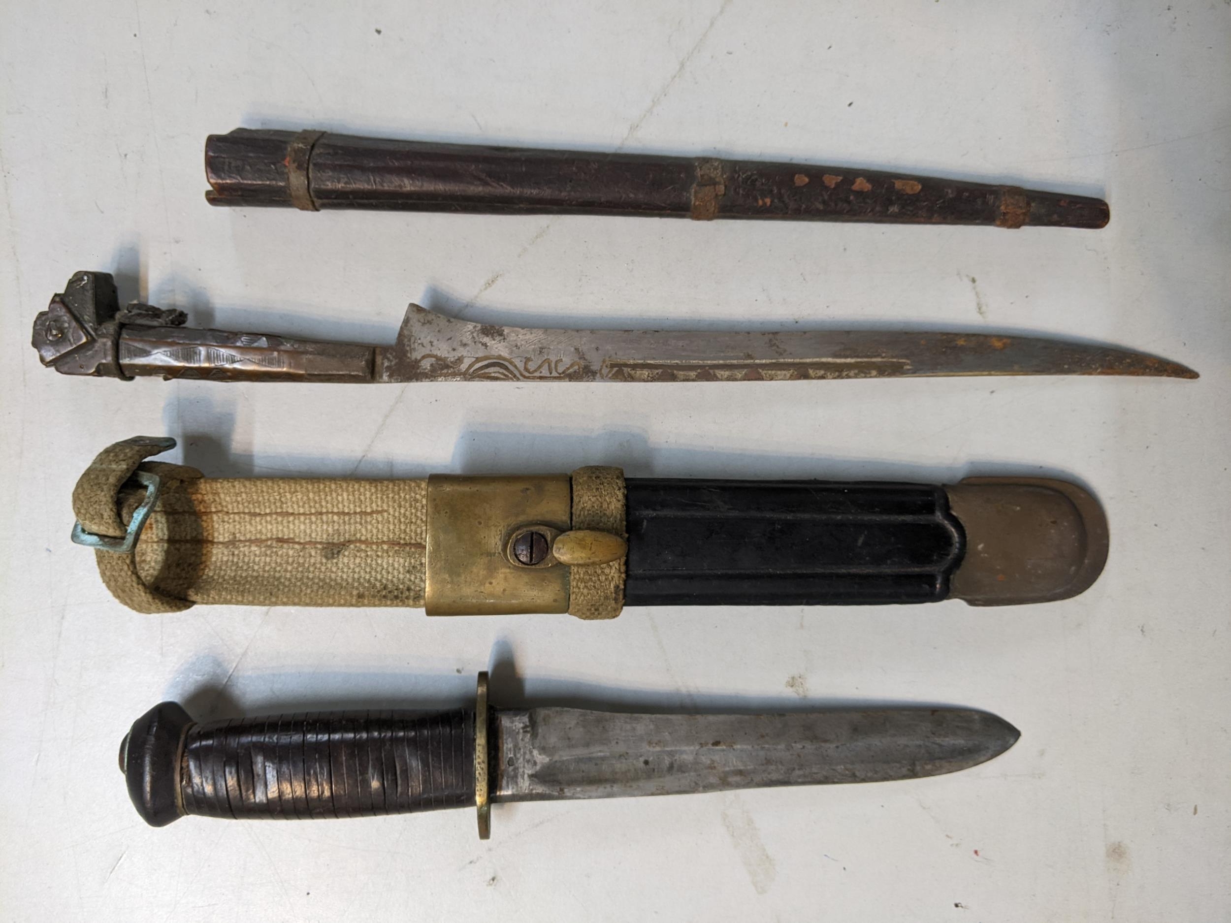 Two knives to include an early 20th century fighting knife, the blade inscribed 'Brescia',