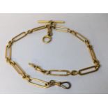 An 18ct gold pocket watch chain with 18ct clips and T-bar and a gold plated dog clip, total weight