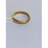 A 18ct gold wedding ring with engraved ornaments, 3.8g Location: