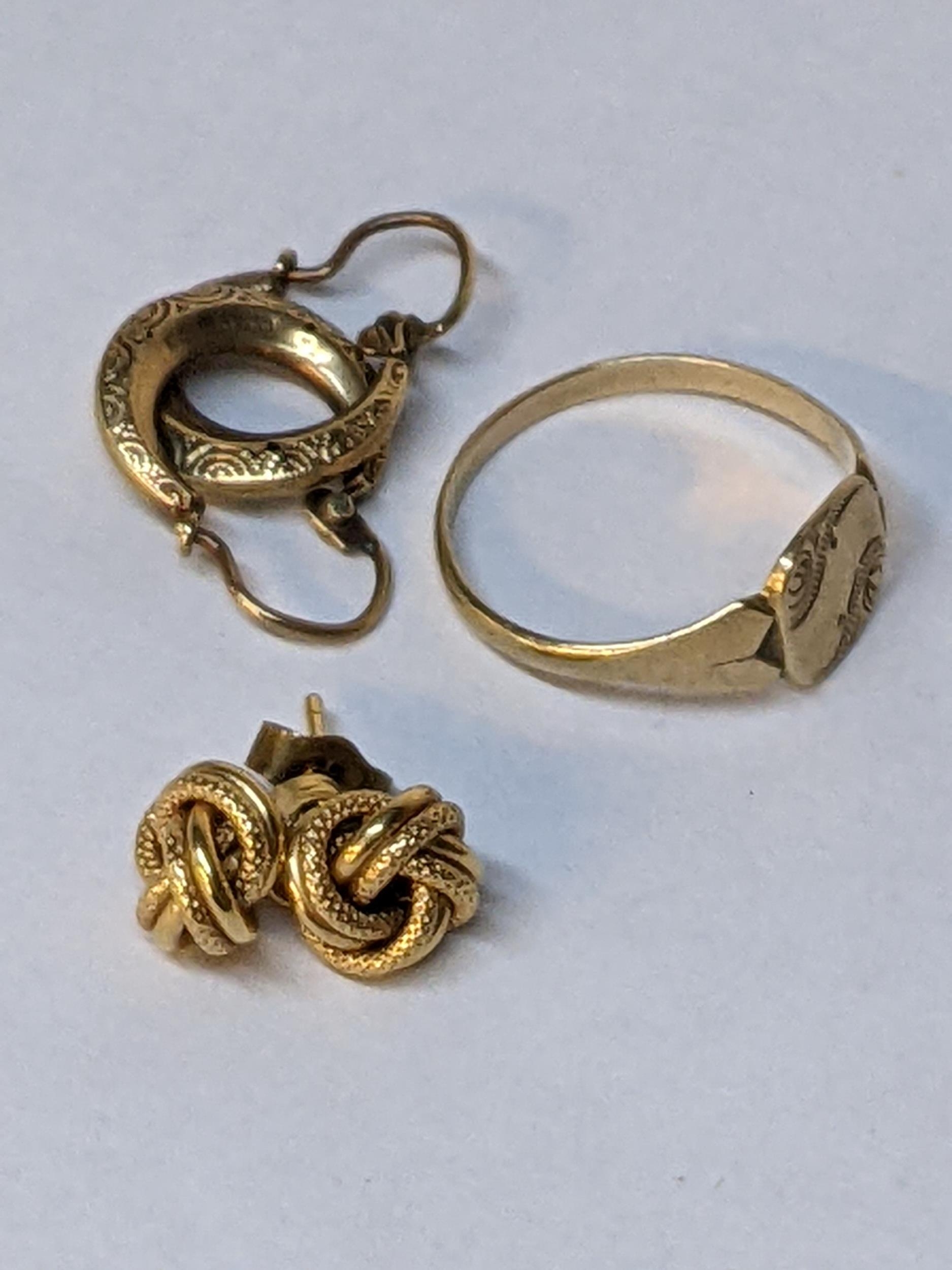 A 9ct gold signet ring, 1.4g and 9ct gold earrings, 0.9g, and another set of 9ct gold earrings, 1.2g
