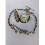An early 20th century silver fob watch by Talis Watch Co, the front decorated with a golfer, 54.