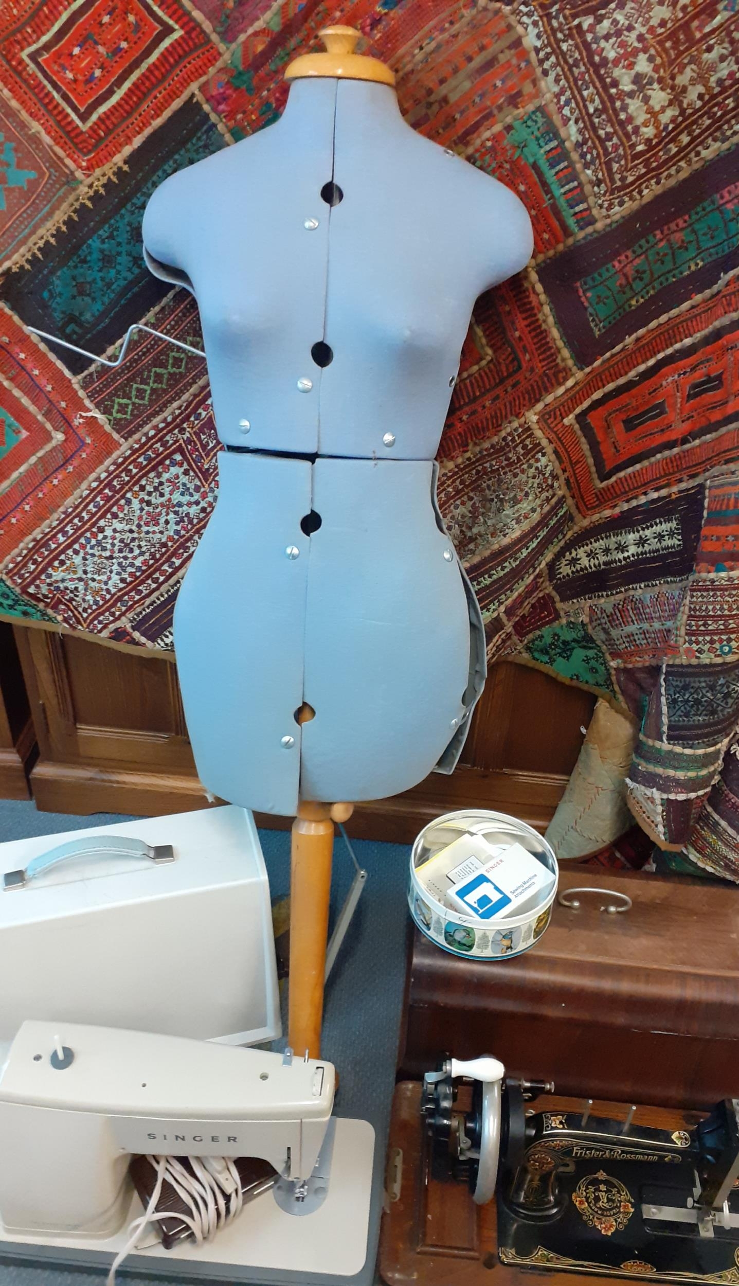 A vintage dress-makers mannequin together with a Frister & Rossmann sewing machine, a retro electric