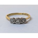 An 18ct gold and platinum diamond three stone ring, 2.1g Location: