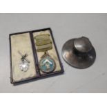 A mid 19th century gold plated masonic medal, a silver capstan style inkwell and a silver fob