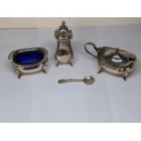 A silver three piece condiments set and two spoons, 184g, with blue plastic liners Location: