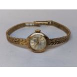 A 9ct gold vintage ladies J.W Benson manual wind wristwatch on a 9ct gold bracelet, 14.8g Location: