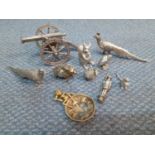 Silver coloured ornaments and trinkets to include models of animals, birds and a canon, together