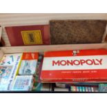 A trunk containing vintage games, chess sets and playing cards together with a small child's chair