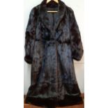 A full length black mink coat, stranded, 44/46" chest x49" long, having a shawl collar with leg of