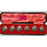 A cased set of 6 early 20th Century silver buttons 'The Cherub Choir' with rope twist border, makers