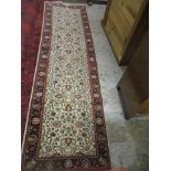 An Indian hand woven runner, allover floral design on a white ground, triple guard border, tasselled