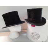 Two early 20th Century black silk top hats, one by Dunn & Co 53cm internal circumference and the