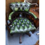 A reproduction green leather button back swivel Captain's armchair Location: