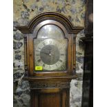 A 1930s oak cased long case clock, the dial with silvered Roman chapter ring, three winding holes,