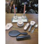 A 1950s enamelled metal and glass dressing table set, an ebony dressing table mirror and brush and a