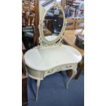 A mid 20th century French style cream painted dressing table with a swing mirror and on cabriole