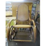 An early 20th century bentwood and cane seated rocking chair