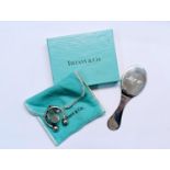 A boxed Tiffany & Co silver folding handbag mirror together with a Tiffany & Co silver keyring, with