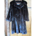 Max Mitzman - a three quarter length black mink coat with a half belt detail to the back, having six