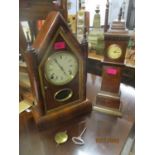 An American Gilbert Manufacturing Company walnut cased mantle clock with white Roman dial