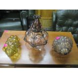 A group of three Italian Seguso style glass and wrought iron caged ceiling pendant lights, one in