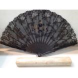 A late 19th Century black lace fan with embroidered metallic thread detail together with original