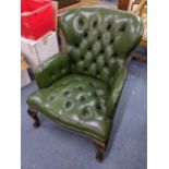 A reproduction green leather button back upholstered armchair on short cabriole legs Location: