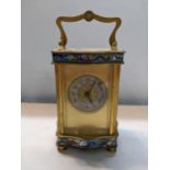 A late 19th century brass and cloisonne carriage of serpentine form, silvered dial with pierced gilt