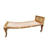 An Egyptian Revival chaise longue, the mahogany frame with gilt carved panels depicting relief