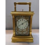 A late 19th century brass cased repeater carriage clock having reeded columns and pierced, gilt