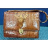 A vintage American Etco crocodile handbag with baby crocodile addition and gold tone hardware.