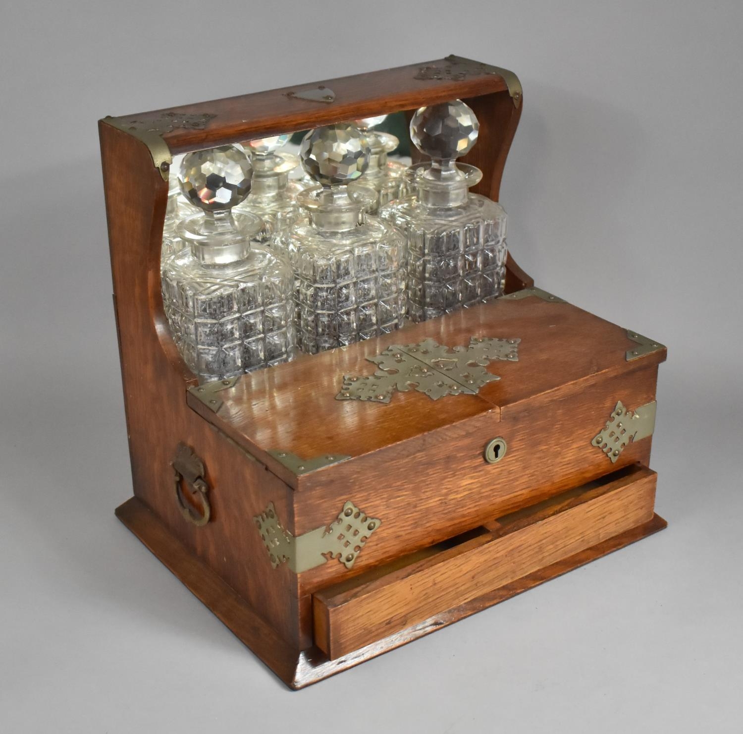 An Edwardian Oak Silver Plate Mounted Combination Three Bottle Tantalus Gaming Box having Mirrored