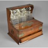 An Edwardian Oak Silver Plate Mounted Combination Three Bottle Tantalus Gaming Box having Mirrored