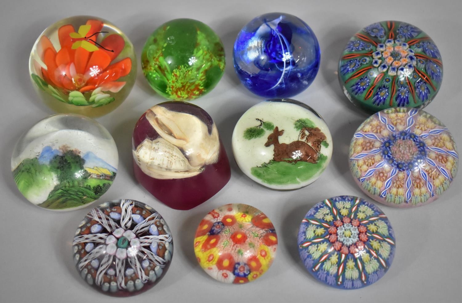 A Collection of Various Glass Paperweights