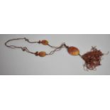A Chinese Jadite Carved and Pierced Pendant on Silk Chain Having Two Smaller Oval Carved Pendants