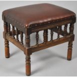 A Leather Topped Stool with Spindle Supports, 40x33x40cms High