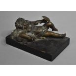 A Bronze Metal Study of a Reclining Cherub on Cushion with Flower in Hand Mounted on Rectangular