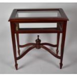 A 20th Century Mahogany and Glazed Bijouterie Table with X Support Culminating in Vase Type