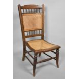 An Early 20th Century Cane Seated and Back Ladies Nursing Chair